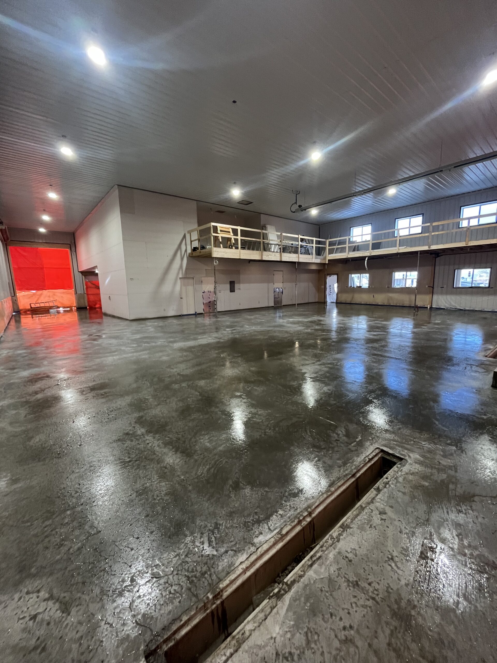large garage with concrete floors and drive through bay