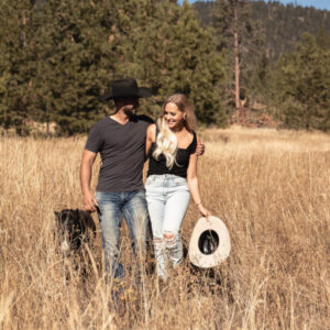 man and woman walking a\in a field