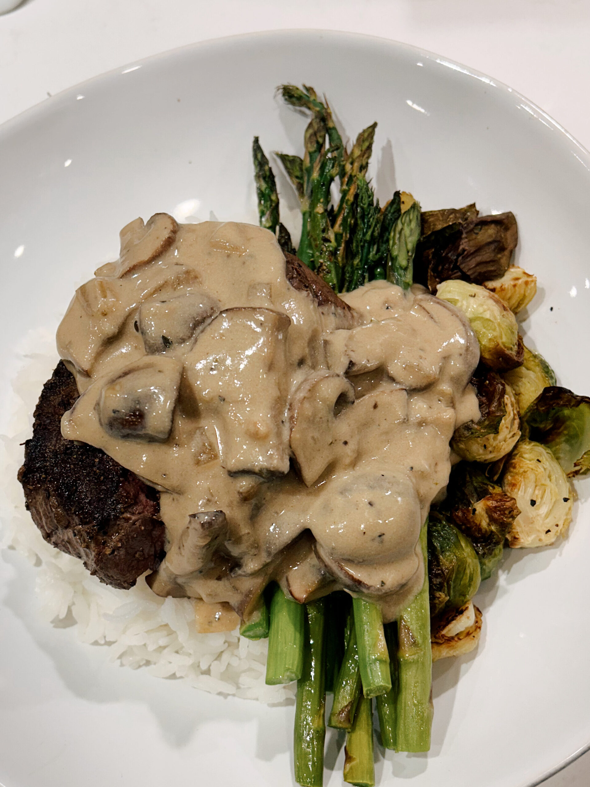 steak and rice with a mushroom cream sauce