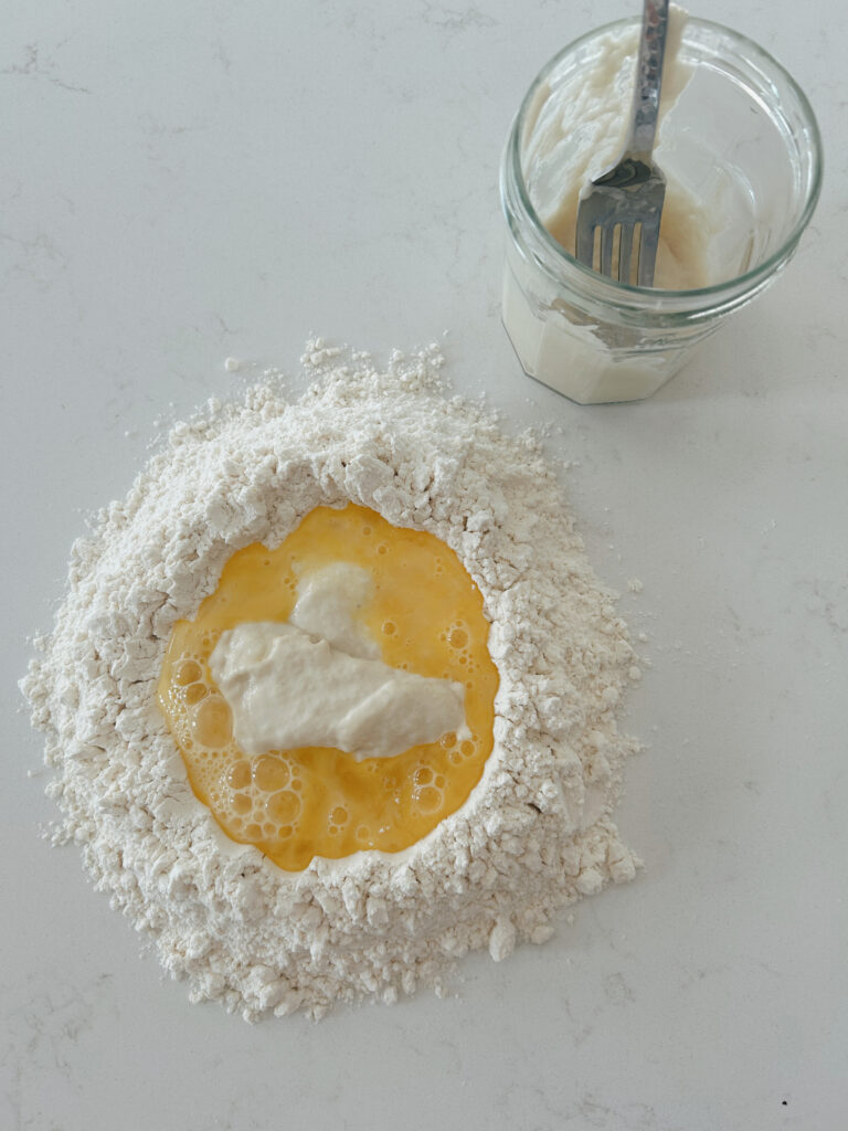 flour and egg on a white counter top