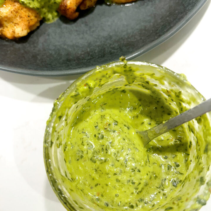green sauce in a jar on a white counter