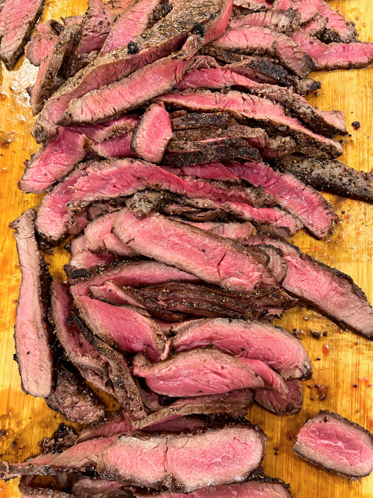pile of steak meat on a wood board