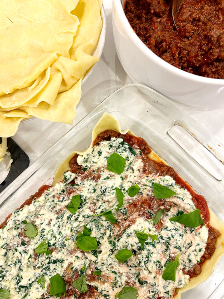 unbaked lasagna in a clear baking dish