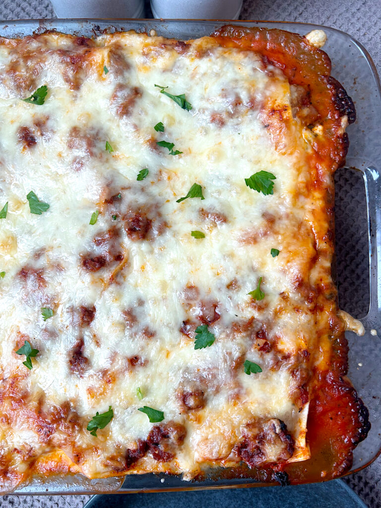 a glass baking dish with homemade lasagna 