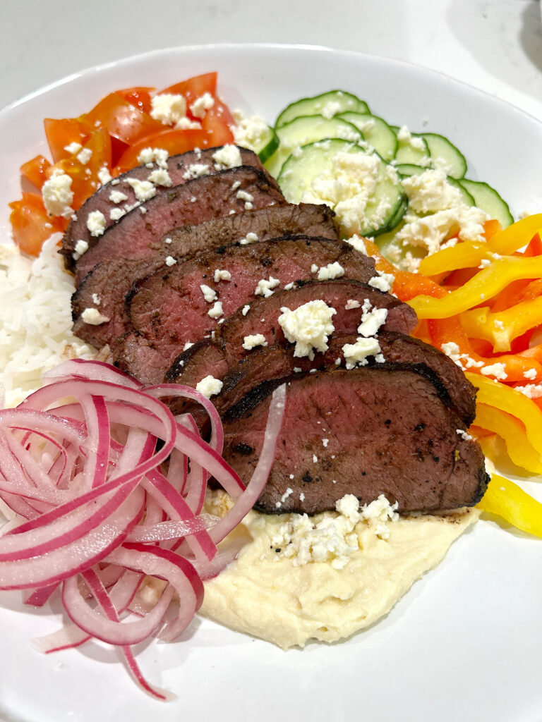 rice bowl with vegetables nd sliced meat