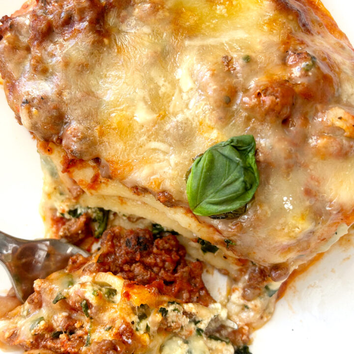 piece of lasagna on a white plate