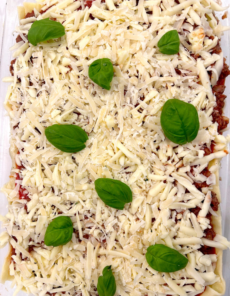 shredded cheese and fresh basil