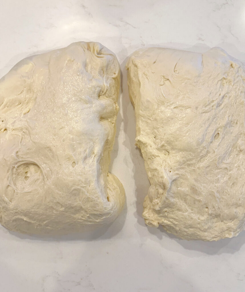 two pieces of bread dough on a white counter