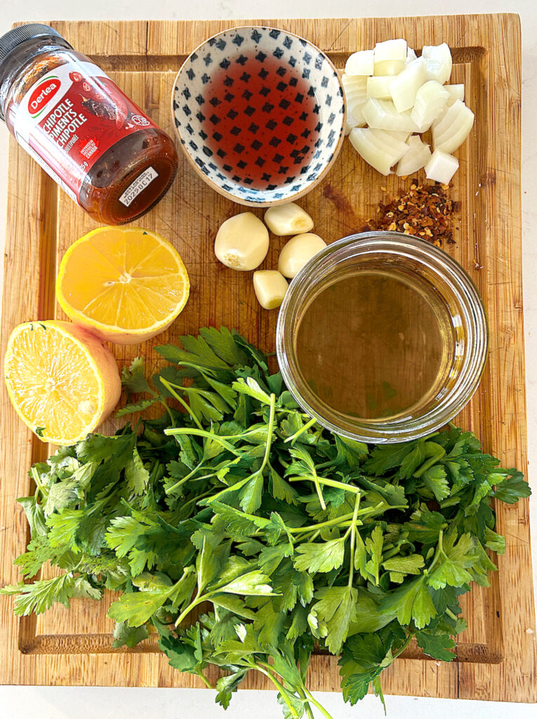 lemon, fresh herbs and garlic on a wood board