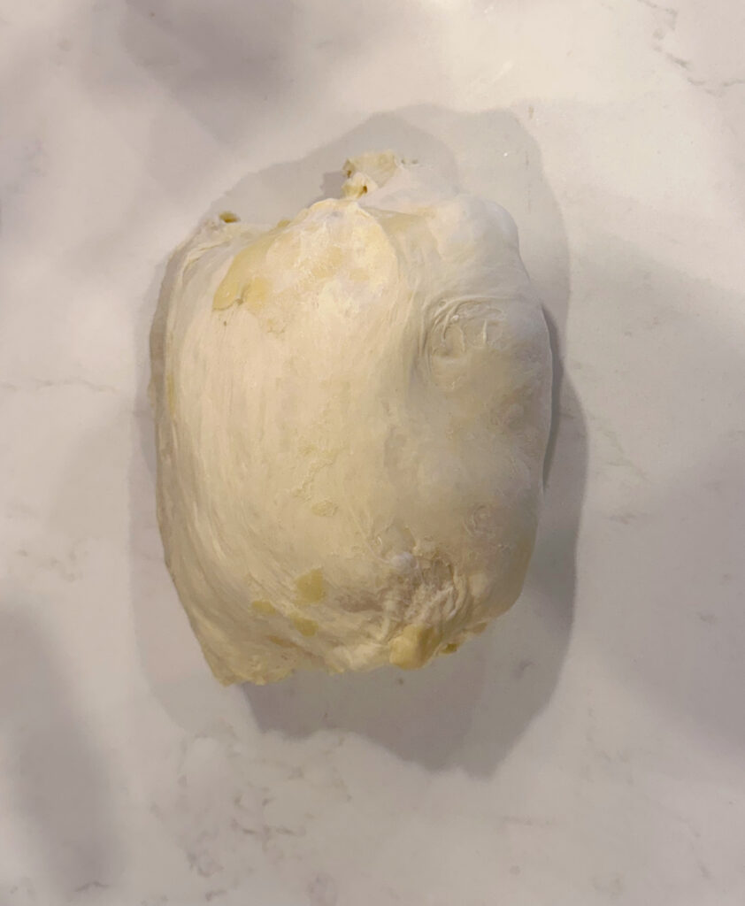 folded dough on a white counter