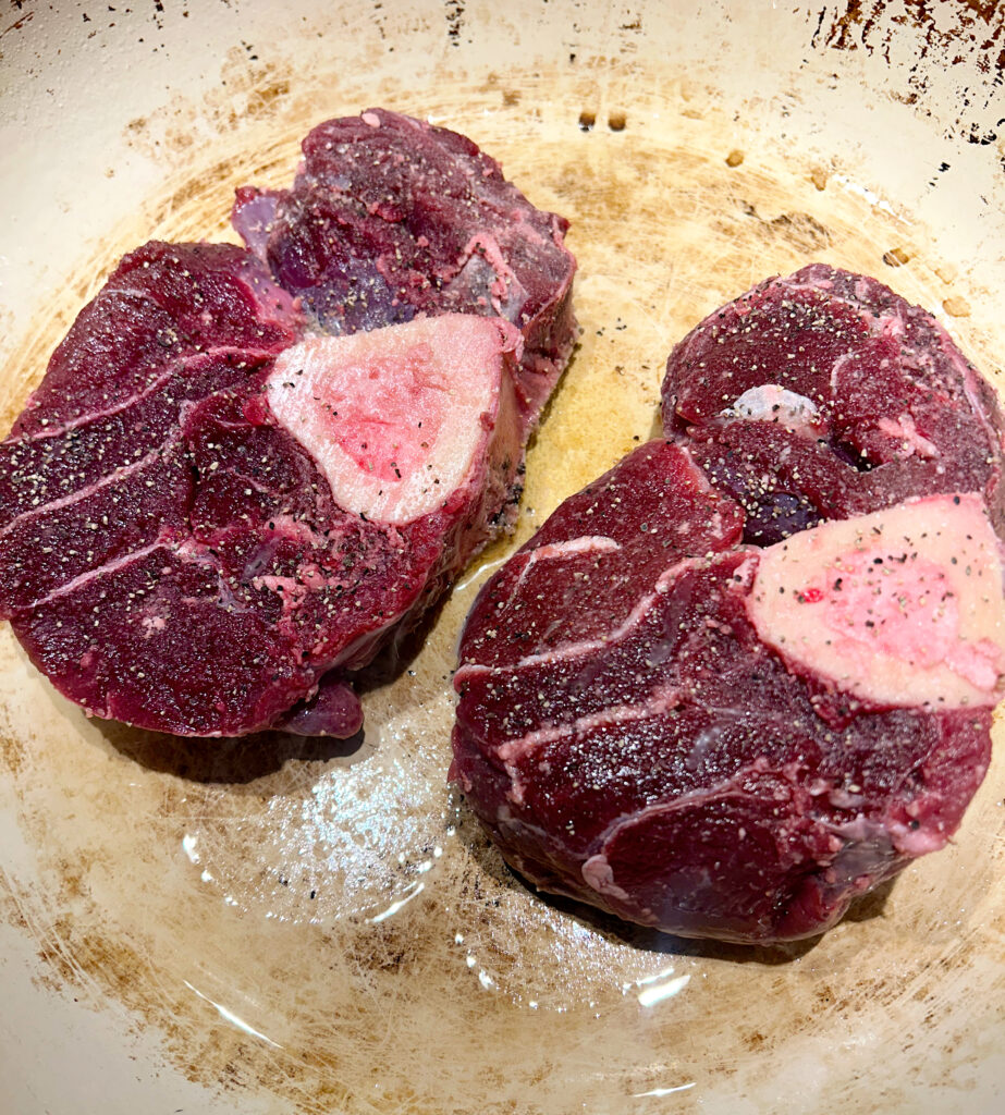raw moose shanks in a skillet