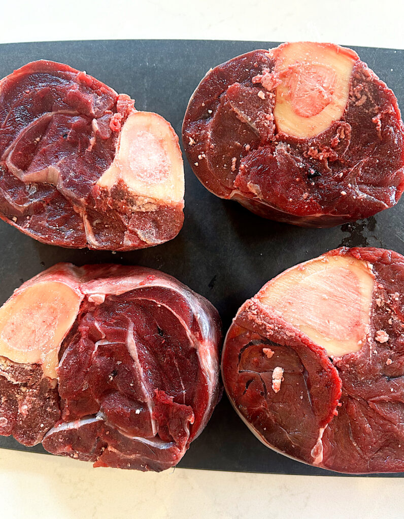 venison shanks on a black board