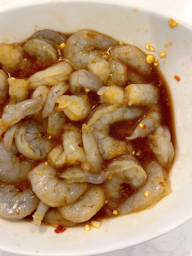 prawns marinating in a white bowl