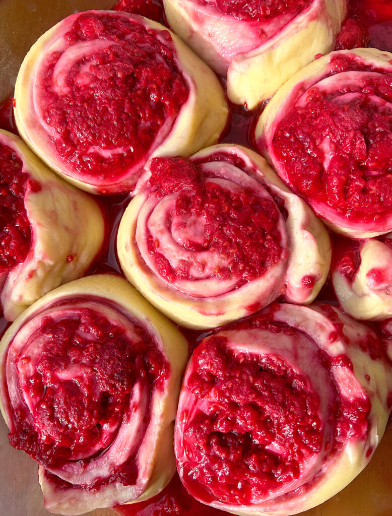 raspberry bread rolls proofing in a pan