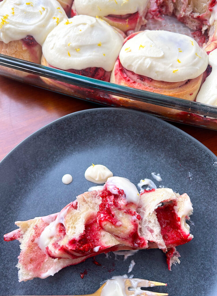 sweet rolls with raspberry filling on a black plate