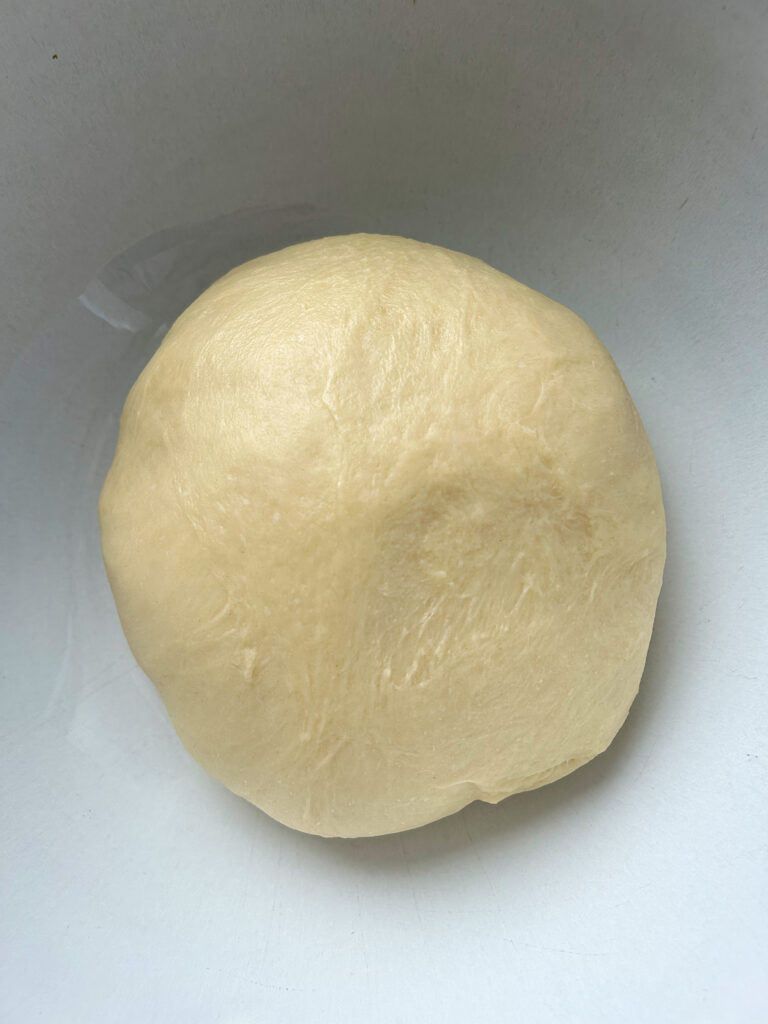 ball of dough in a white bowl