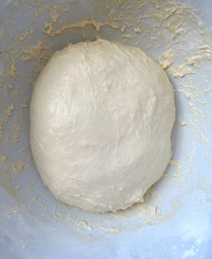 bread dough in a white bowl