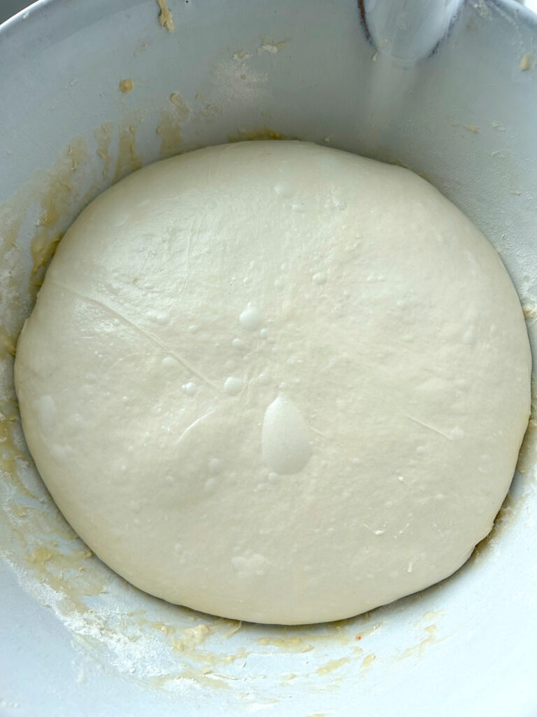 bread dough in a white bowl