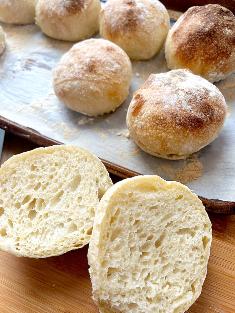 fresh baked sourdough buns on a baking sheet