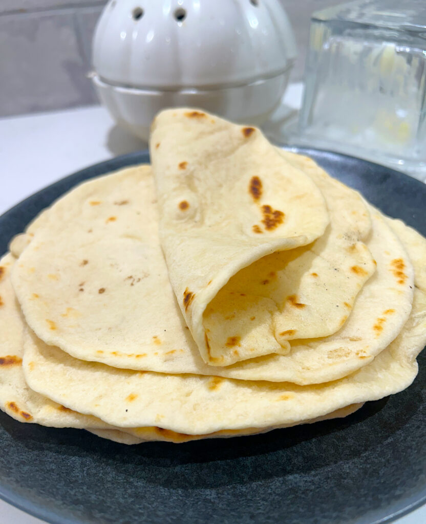 soft stack of tortillas on a grey plate