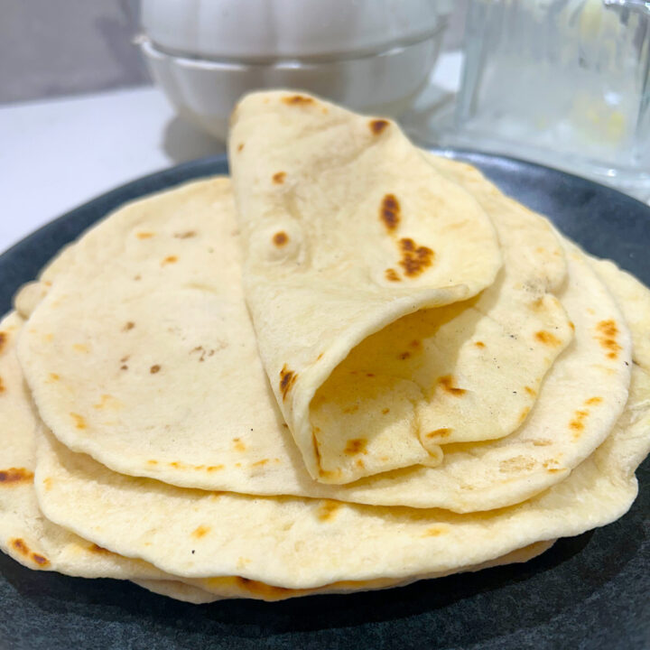 soft stack of tortillas on a grey plate