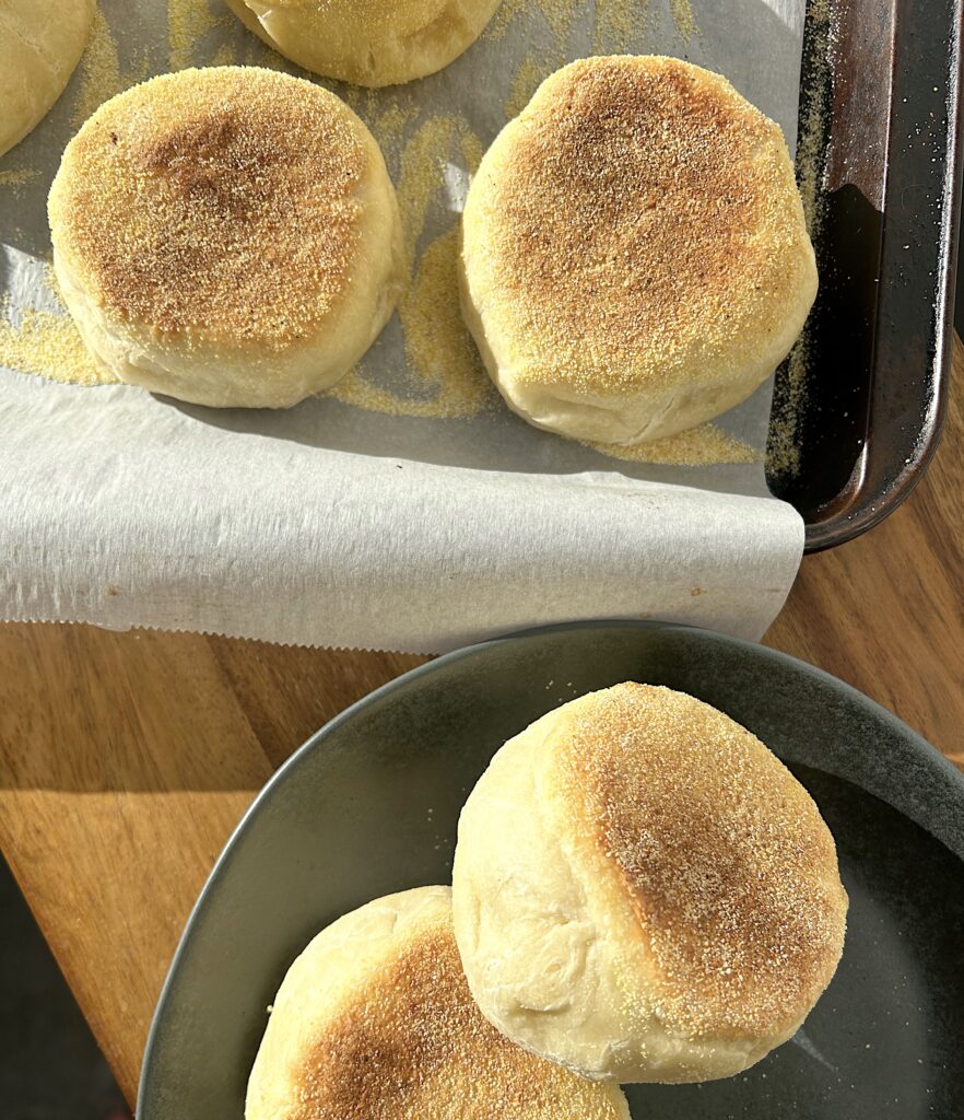 baked English muffins on a wood table