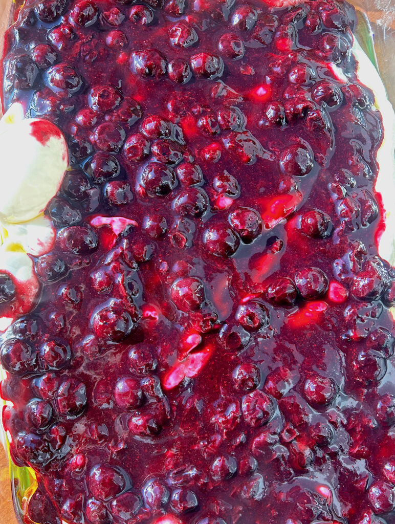 focaccia bread dough covered in blueberry sauce