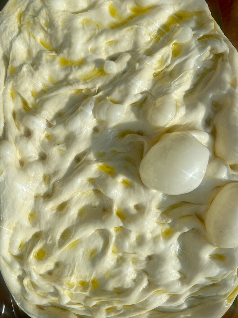 dimpled sourdough focaccia dough with oil