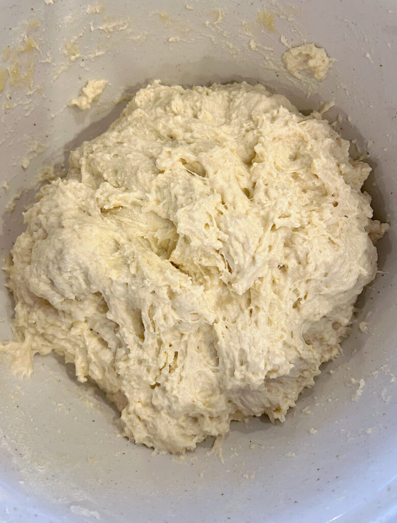 sourdough bread dough in a white bowl