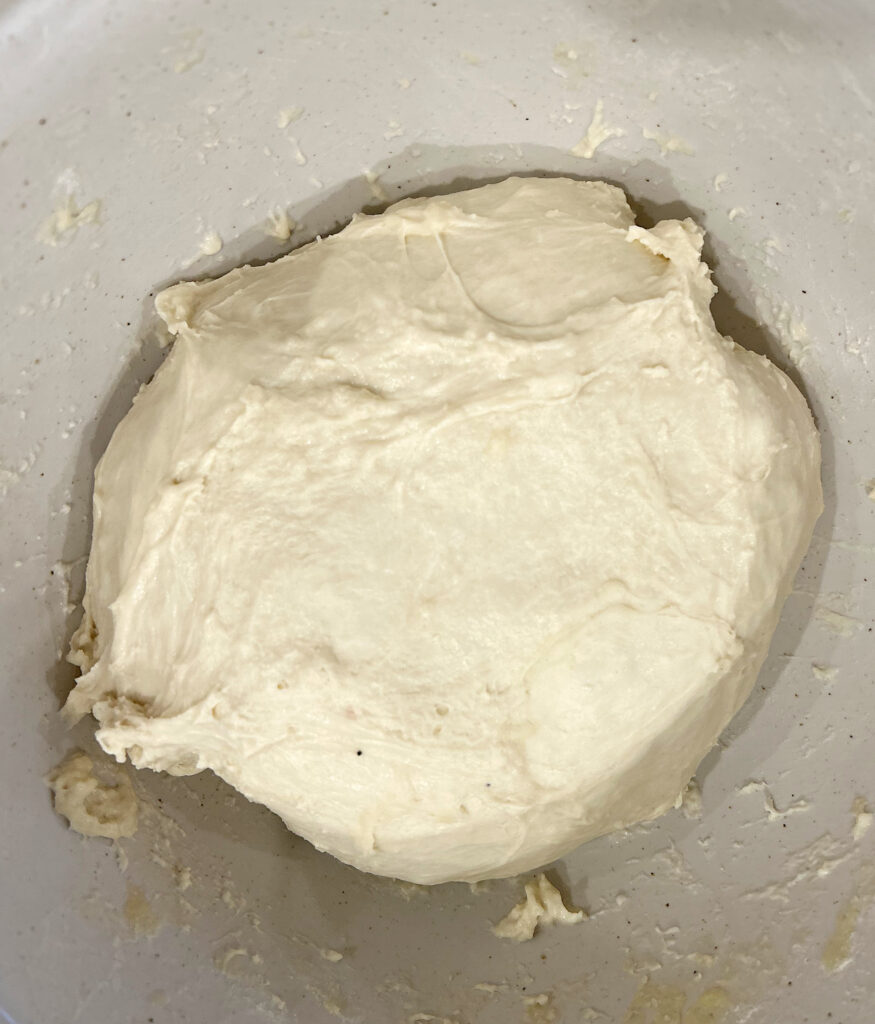 sourdough bread dough in a white bowl