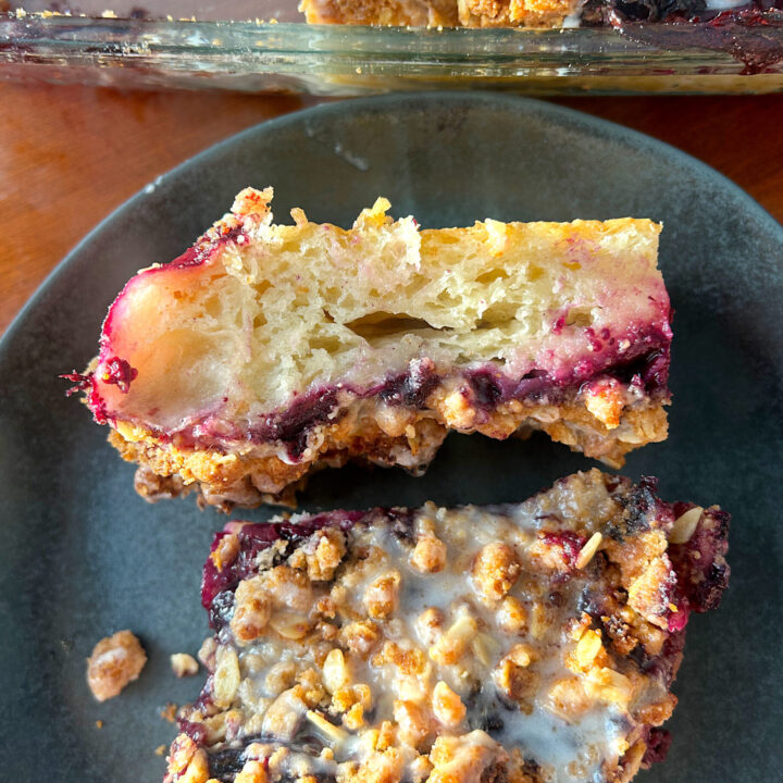 sourdough with blueberry filling and a crumble topping on a black plate