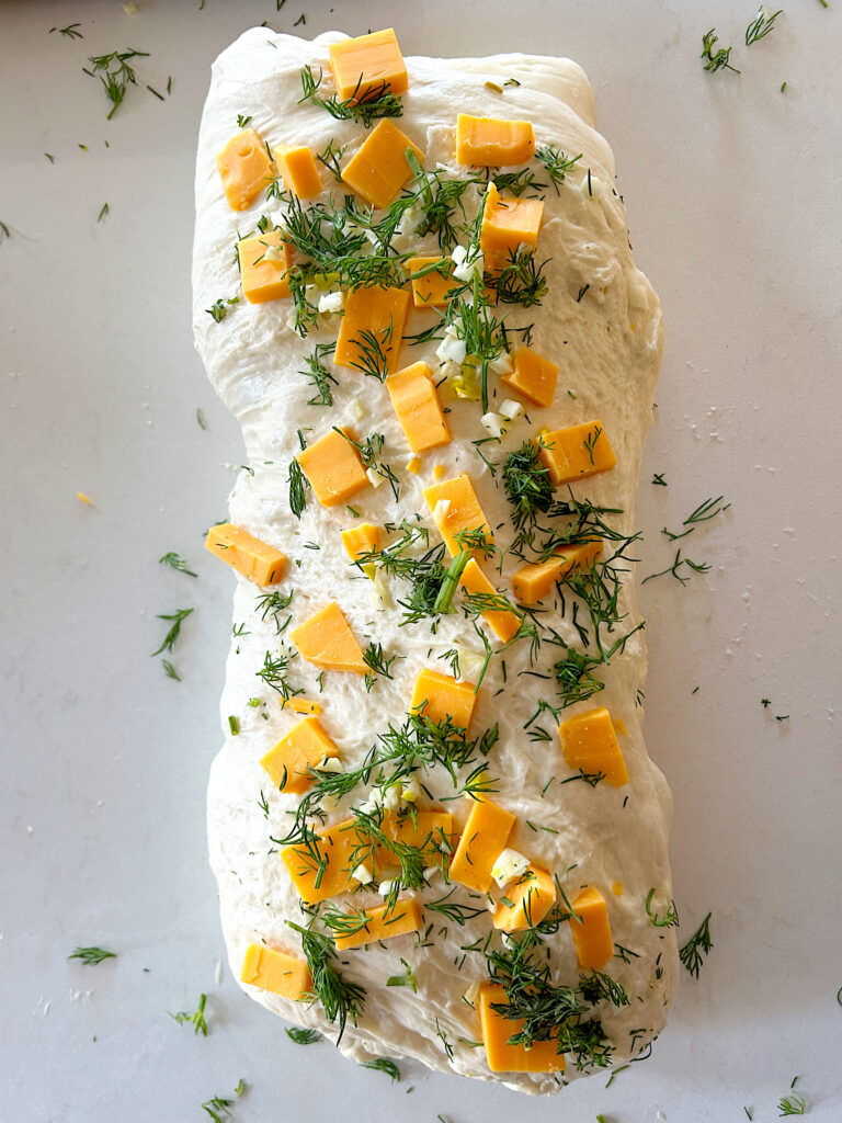 bread dough folded with cheese cubes and dill