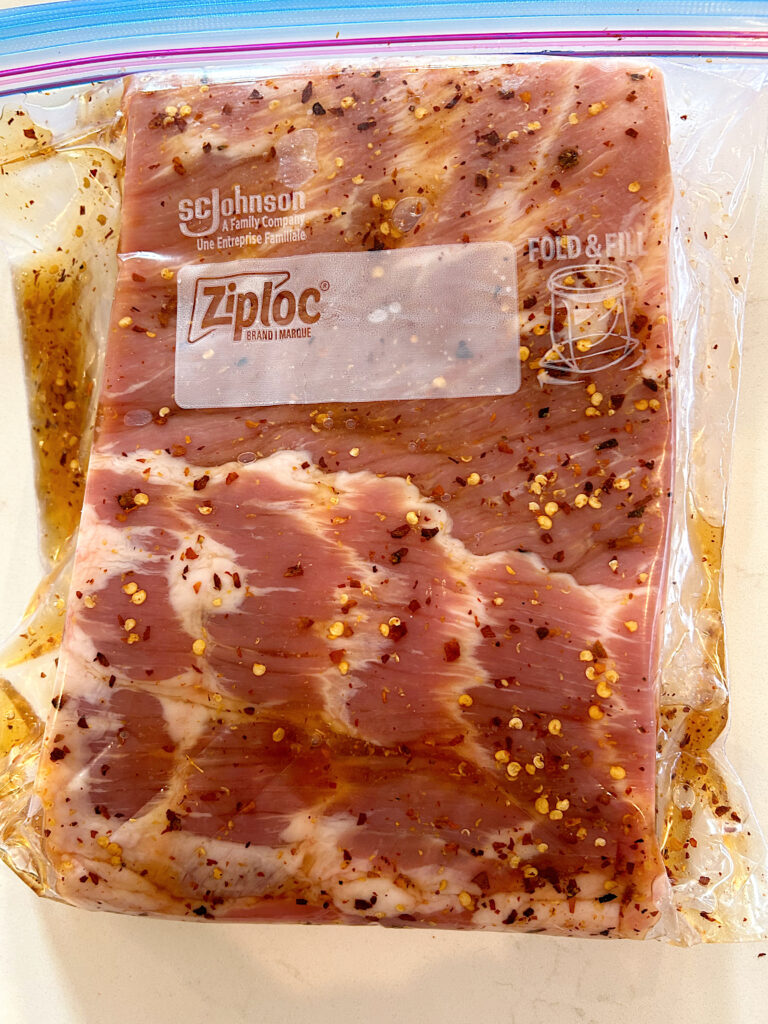 pork belly with chili flakes and maple syrup in a plastic bag