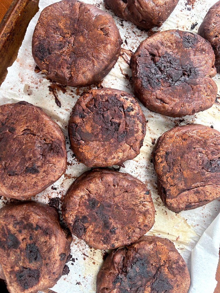 fresh baked chocolate English Muffins on a baking sheet