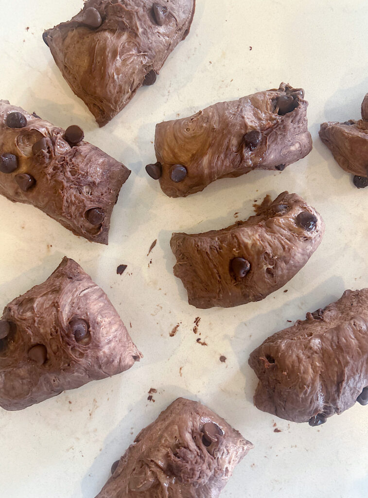 chocolate dough cut into small pieces on a white counter