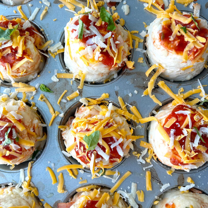 unbaked pizza buns in a muffin tin