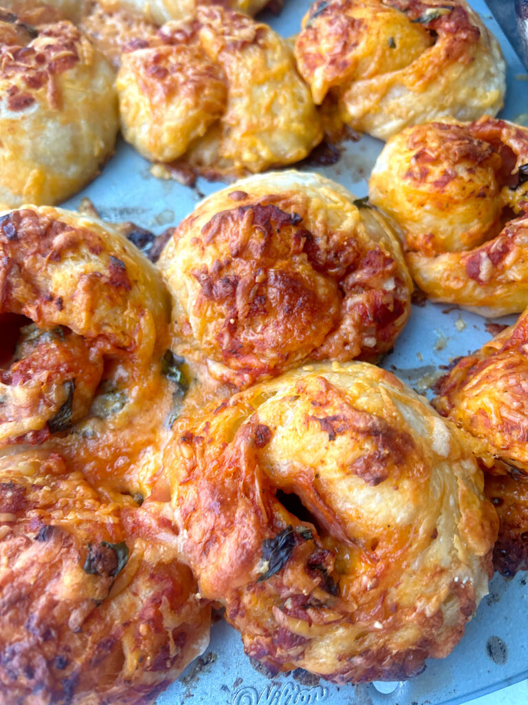 cheesy baked buns in a muffin tin