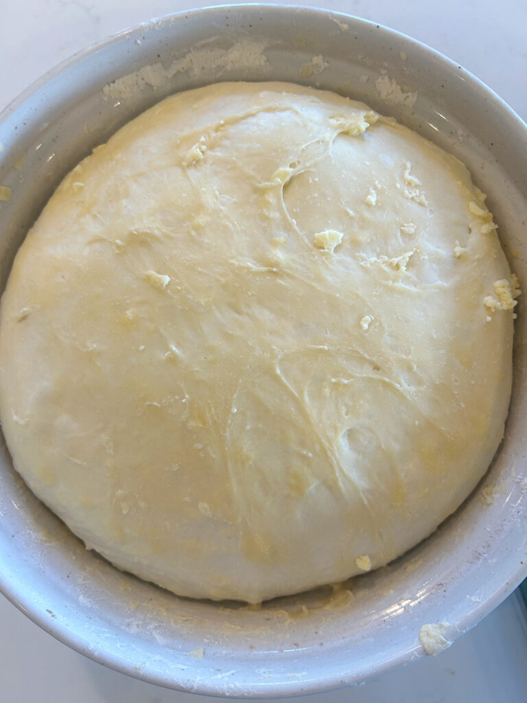 sourdough bread dough in a white bowl