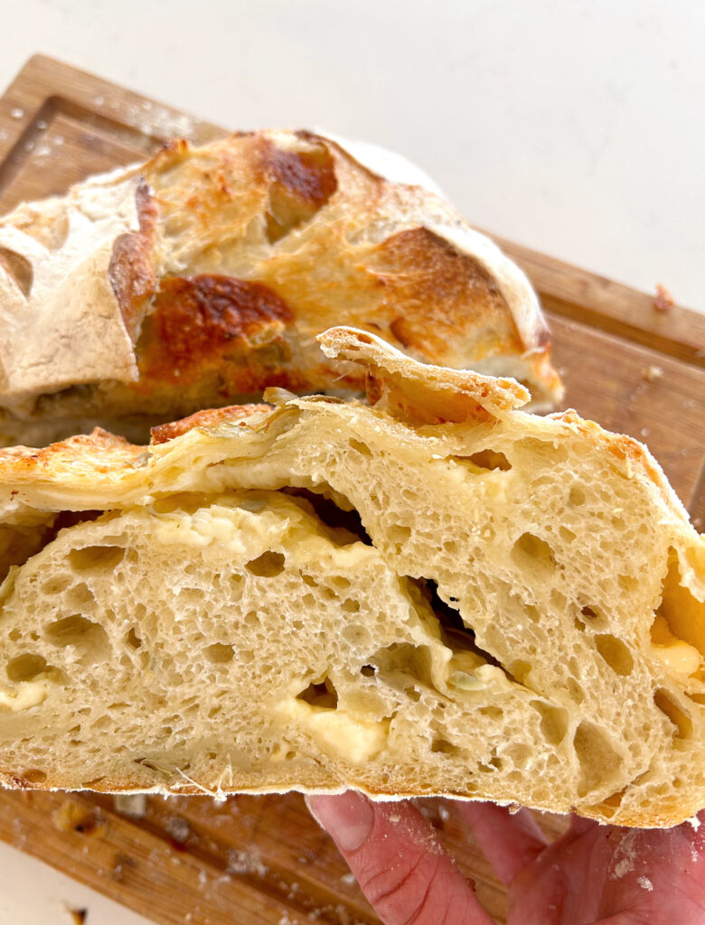 sliced bread with cheese and artichokes inside