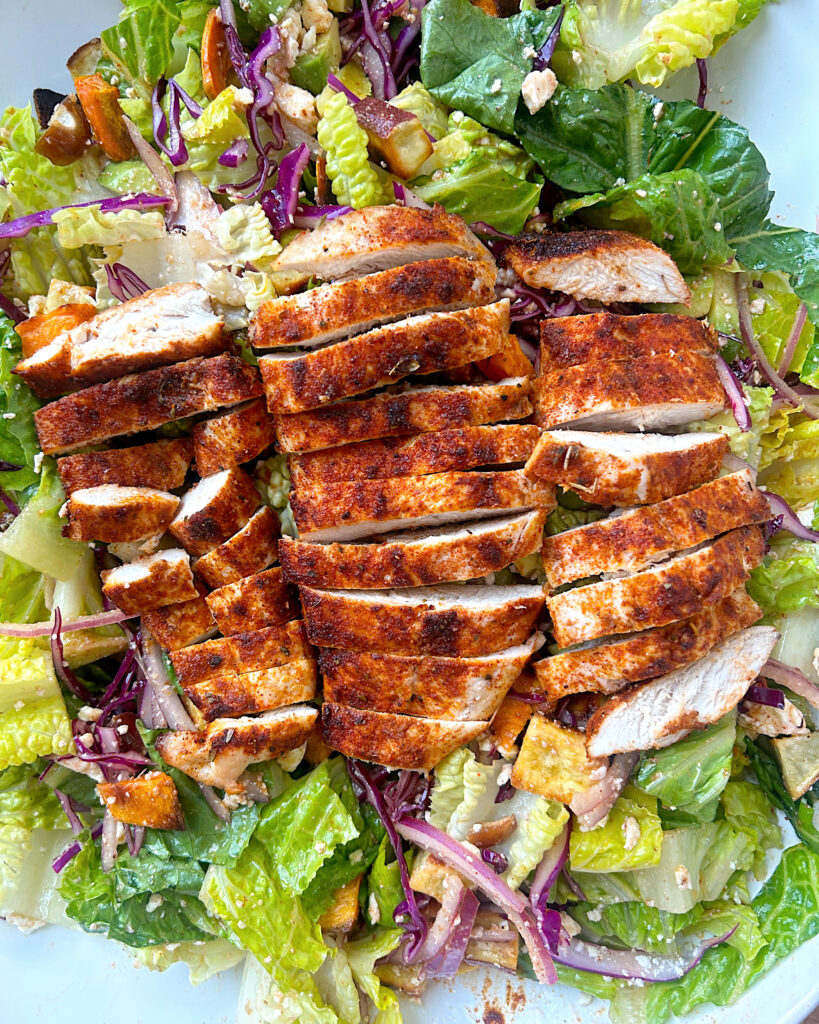 salad with blackened chicken on top