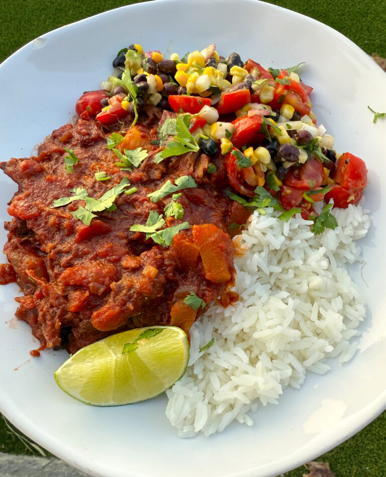bowl of rice, chipotle pineapple venison and fresh corn and avocado salsa