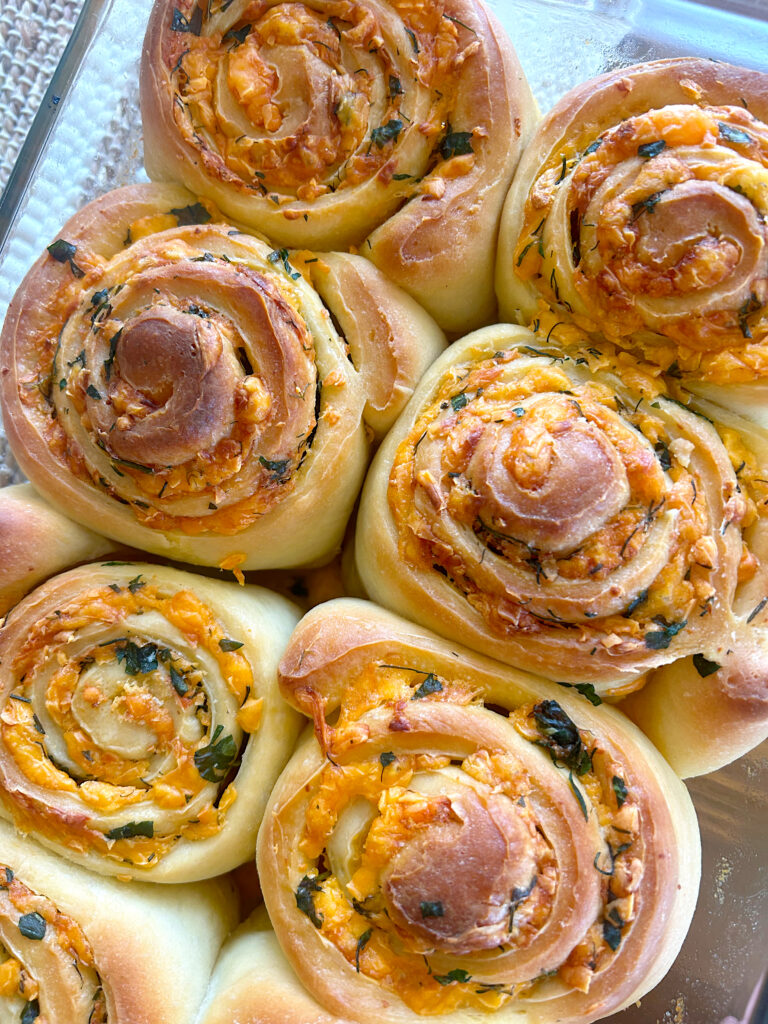 cheese, herb and butter sourodugh buns in a baking dish