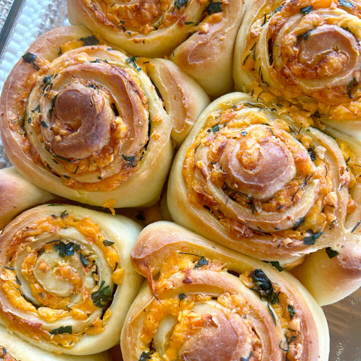cheese, herb and butter sourodugh buns in a baking dish