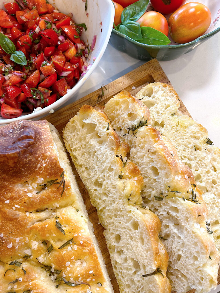 sliced focaccia bread on a wood board
