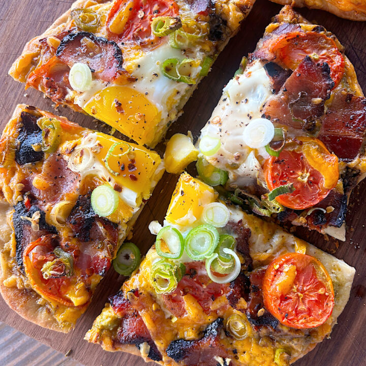 crispy pizza with cheese, bacon, tomato and egg but into 4 pieces
