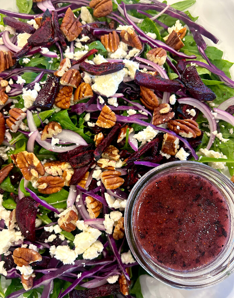 salad with beets and pecans with a blueberry dressing in a jar