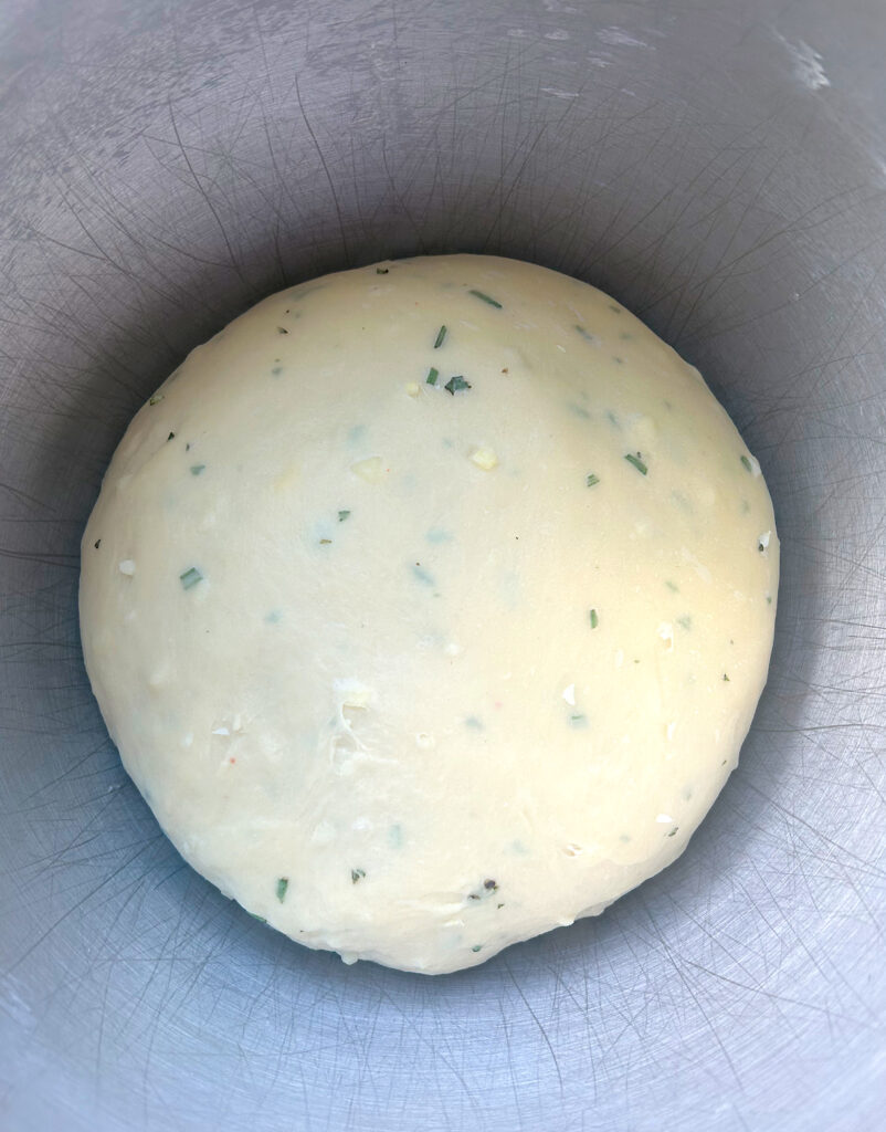 rosemary garlic bread dough in a stainless bowl 