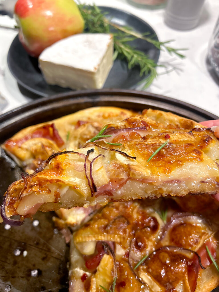 a slice of thin crust sourdough hot honey pizza