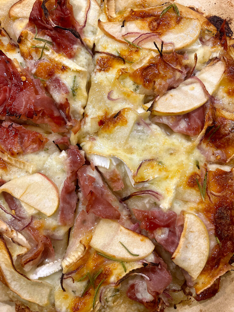 prosciutto and brie sourdough pizza sliced