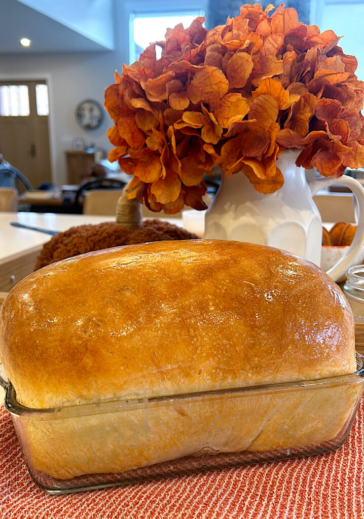 golden baked sourdough sandwich bread in a loaf pan